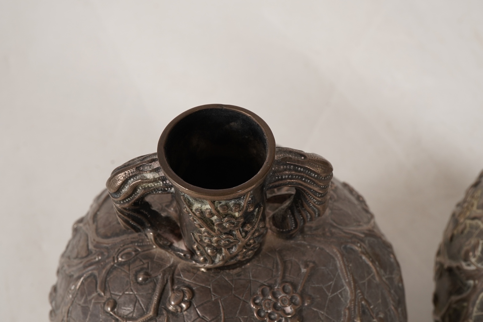 A pair of late 19th/early 20th century Chinese Export white metal two handled globular vases, by Wang Hing, Hong Kong